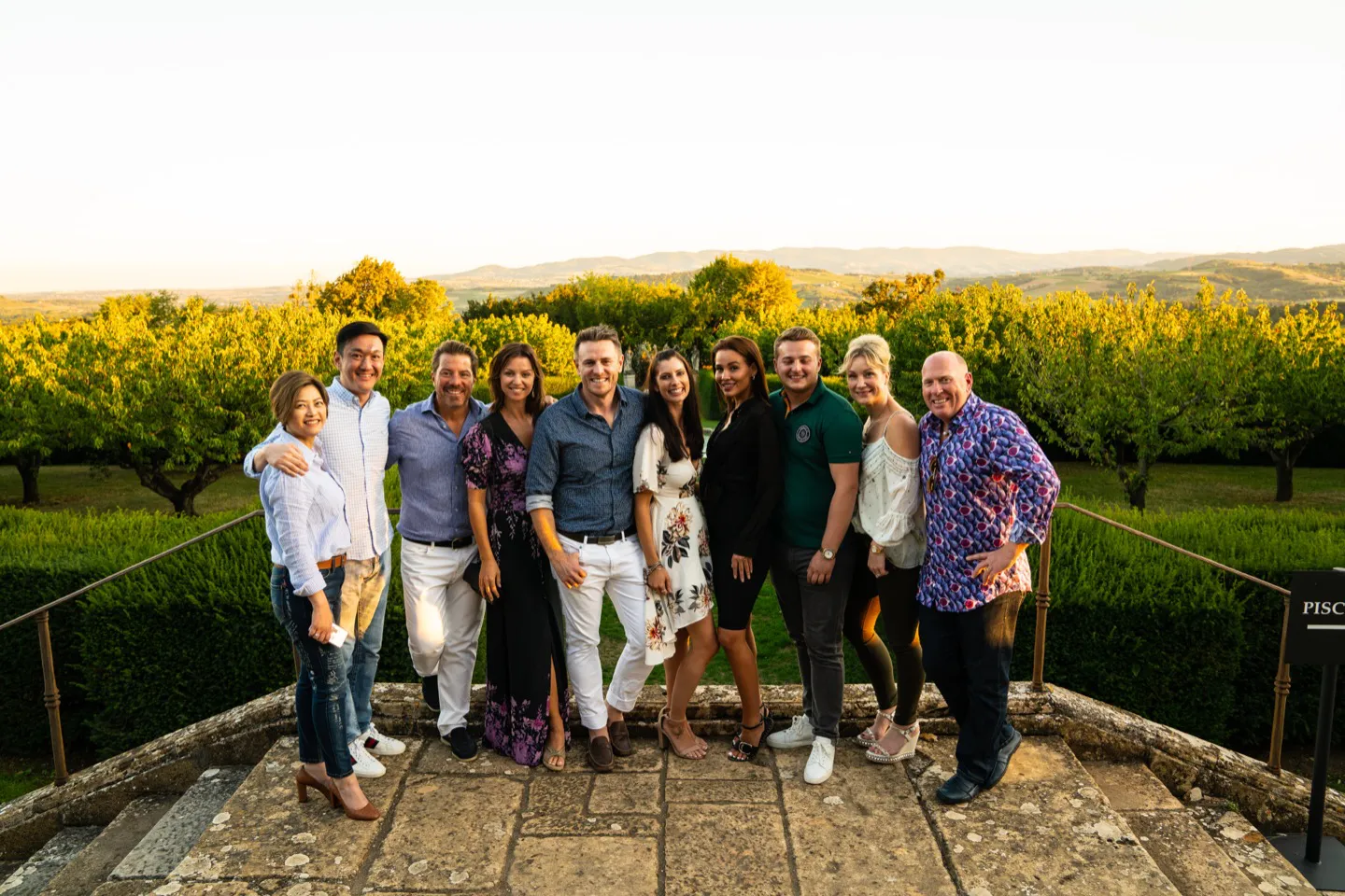 Guests standing in front of a vineyard in Beaujolais on a luxury tour of France