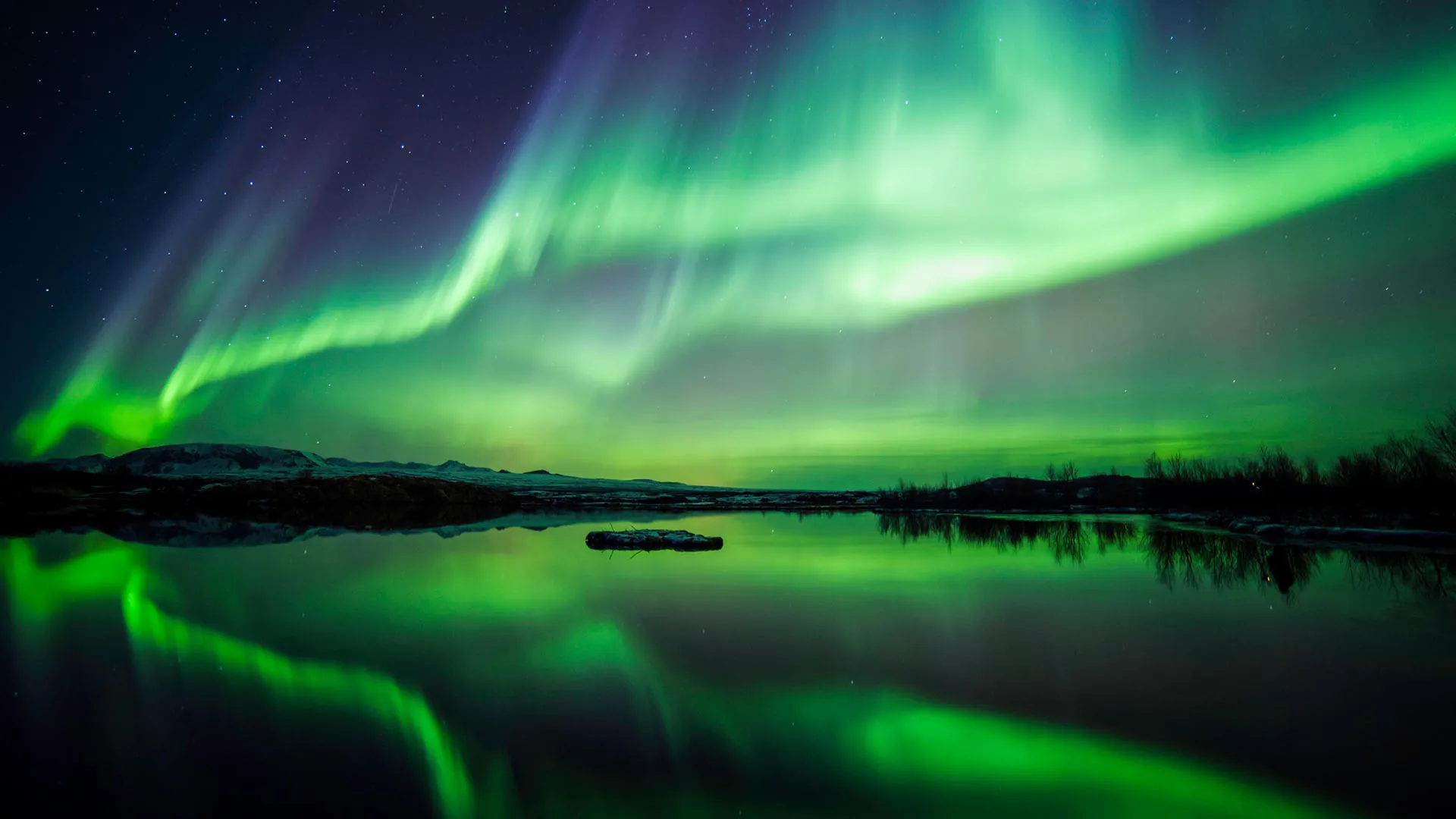 The Aurora Borealis (Northern Lights) over a lake in Iceland