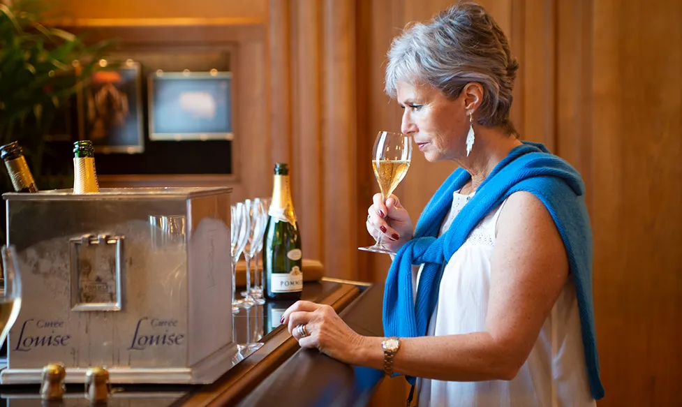 A woman tastes a glass of Pommery Champagne in Champagne, France