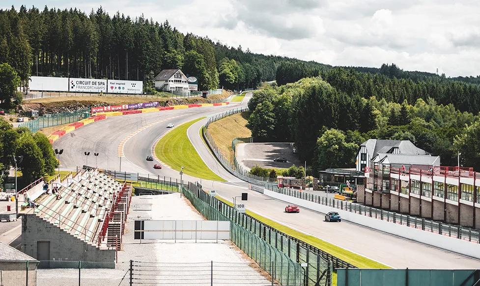 Supercars climb a hill on the famous Spa race track in Germany