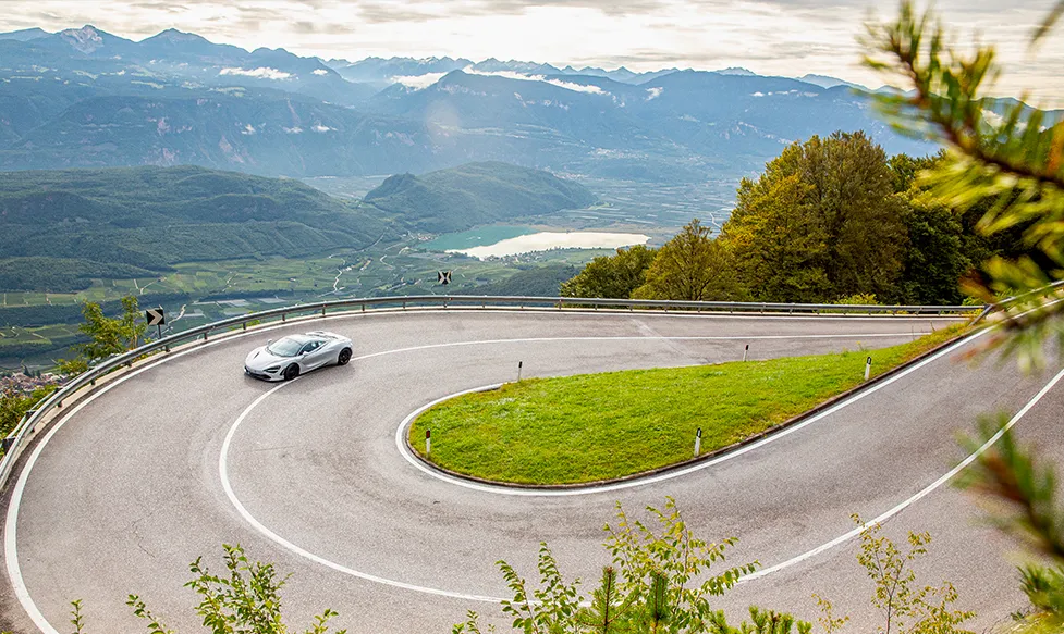 A McLaren drives up a steep hill in the Tuscan countryside on an Ultimate Driving Tours luxury tour of Tuscany