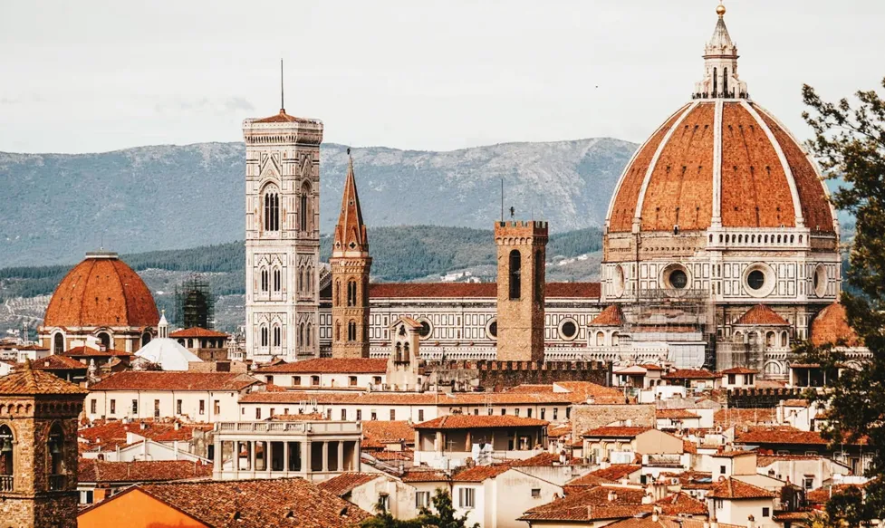 A skyline shot of Florence, Italy shows the red brick roof of the city’s cathedral