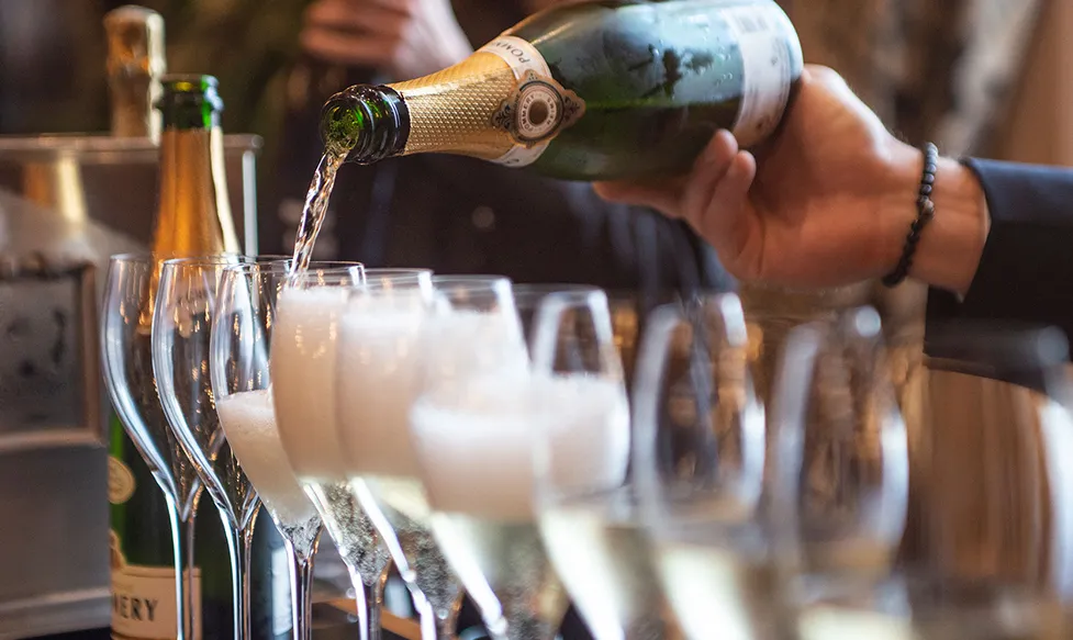 ‘A bottle of Pommery Champagne is poured expertly into a line of flutes