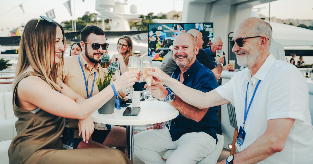 Four happy guests on the Ultimate Driving Tours chartered superyacht at Monaco Grand Prix