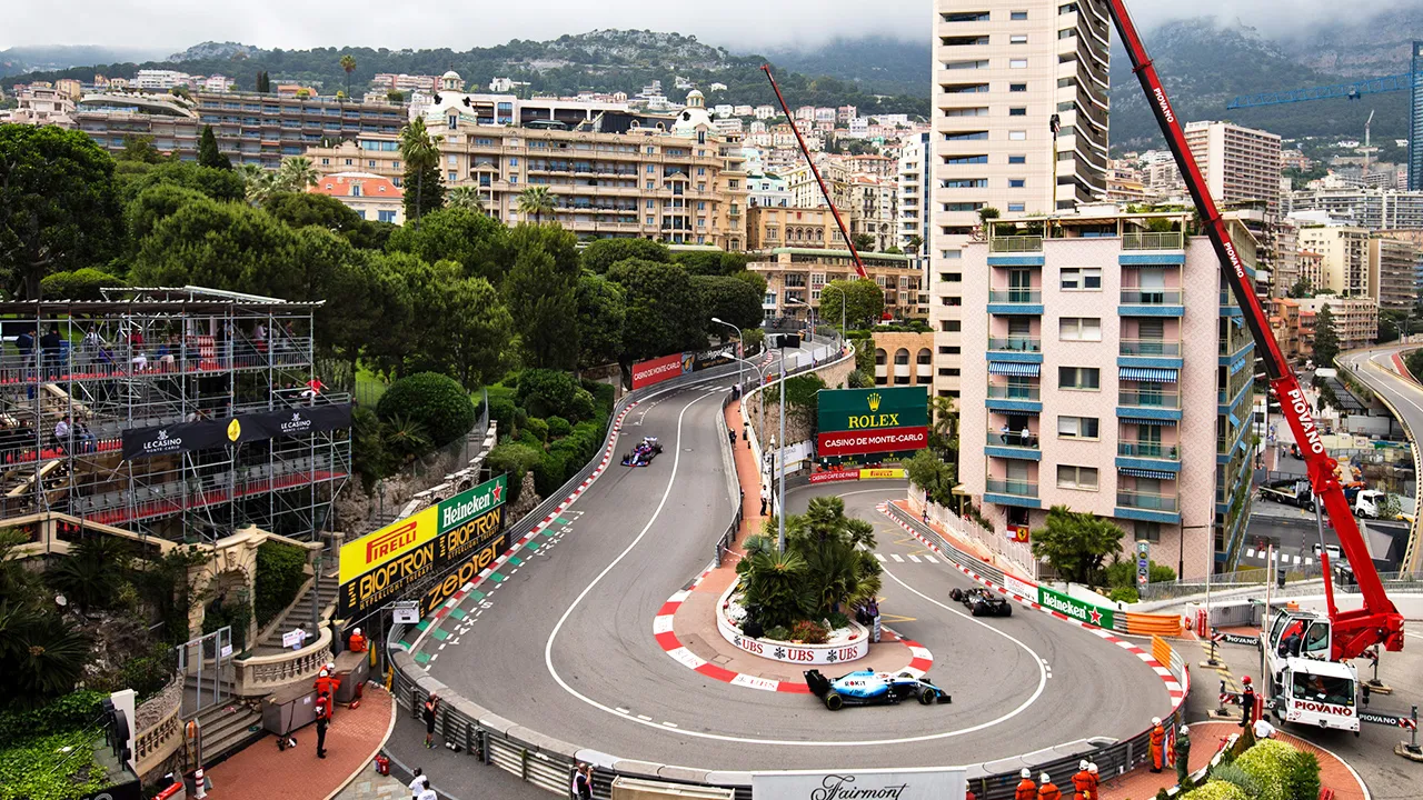 Race cars cutting into a corner on the Monaco Grand Prix  street circuit