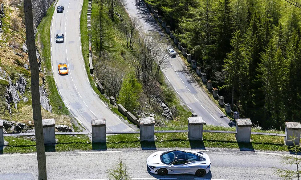 McLaren 720S on a road overlooking the Ultimate Driving Tours fleet of supercars
