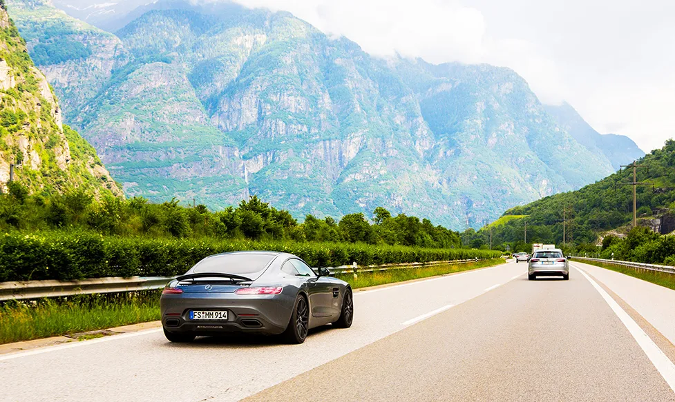 A grey Mercedes GTR, seen from the rear, on a highway during an Ultimate Driving Tours luxury holiday