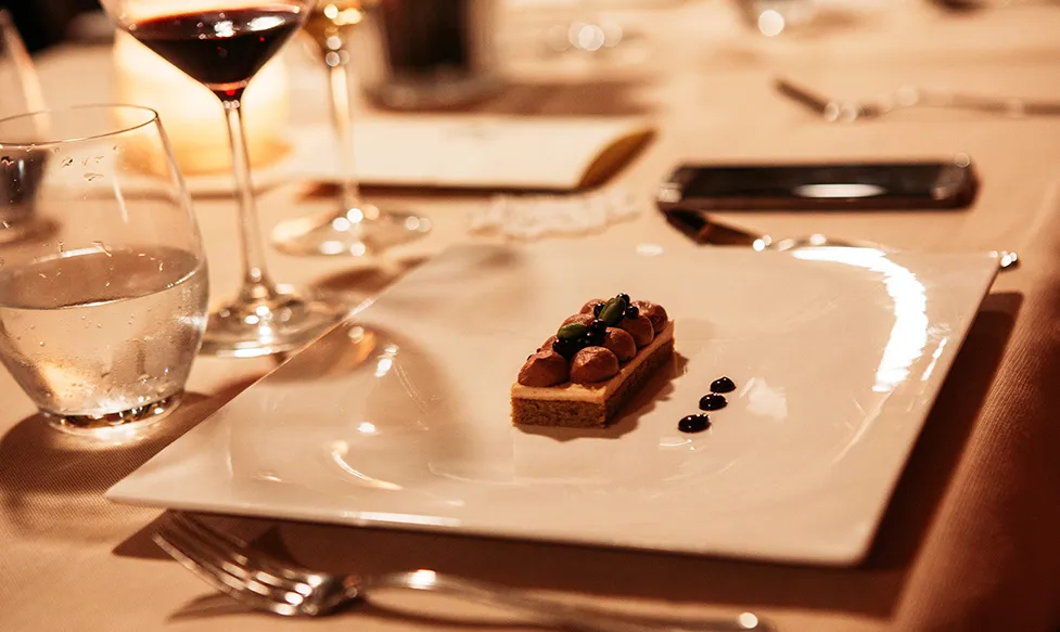 A delicate dessert sits on a plate during a meal on an Ultimate Driving Tours supercar tour