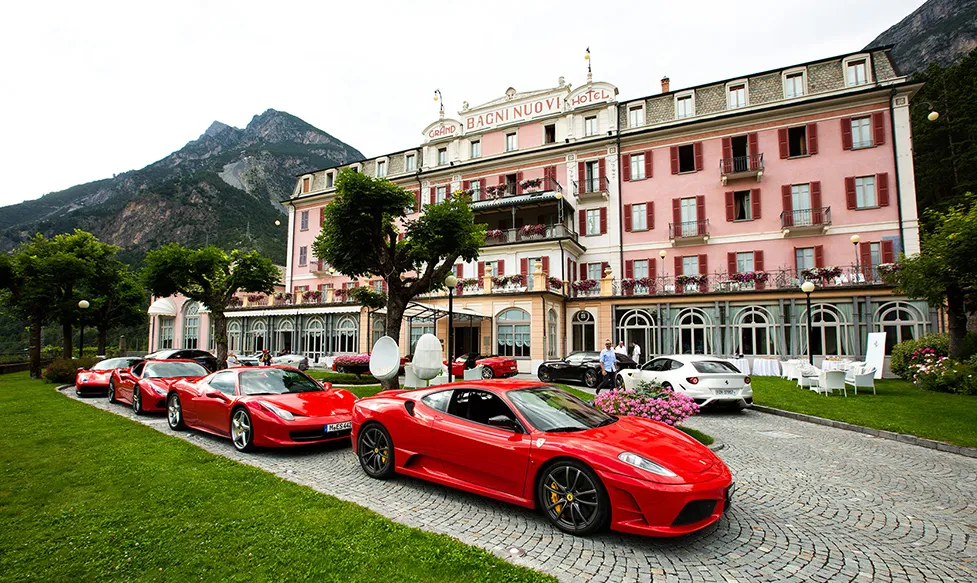 A line of red Ferraris sit outside the entrance of the Grand Hotel Bagni Nuovi, Molina, Italy