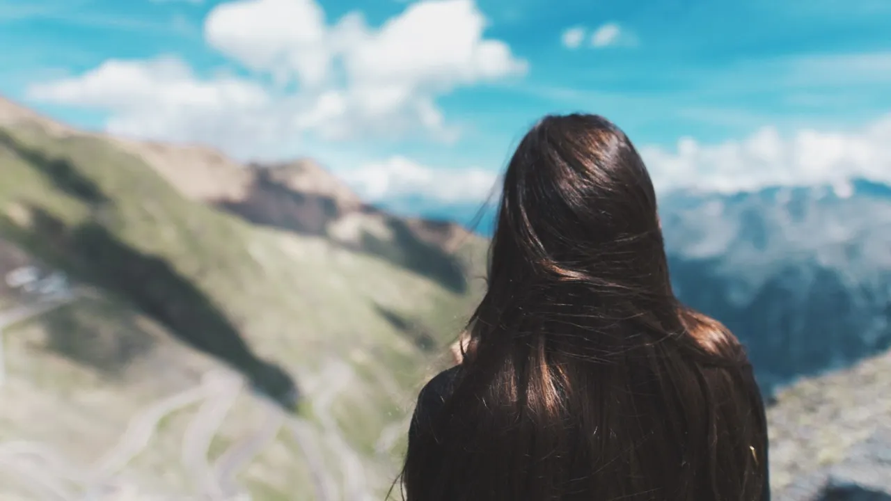 A women overlooking the Stelvio Pass from a distance