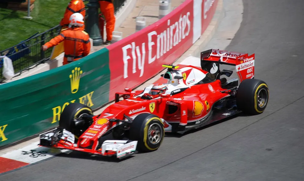 A Ferrari formula 1 car brushes the apex of a corner during the Monaco Grand Prix