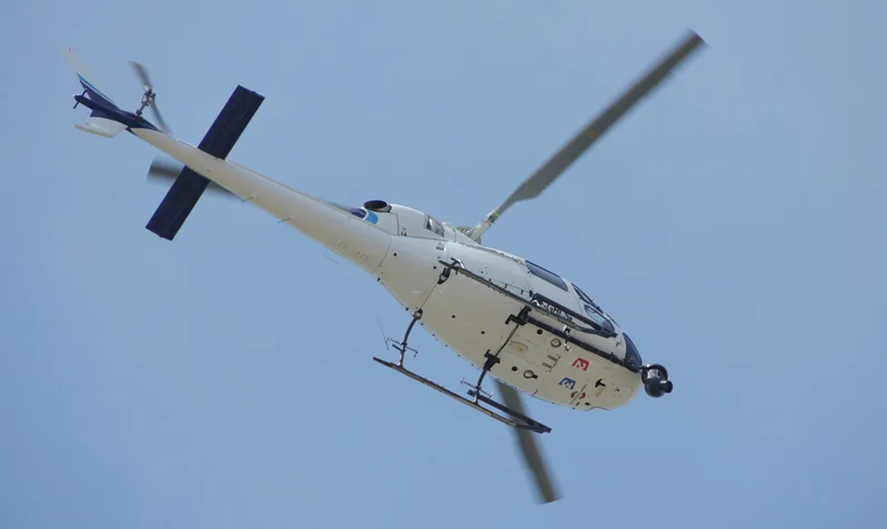 A helicopter, seen from below, as it transports Ultimate Driving Tours' guests to the race at Monaco