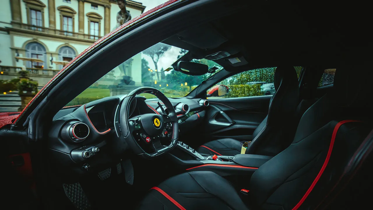Close up of the interior of a modern supercar with black seats.