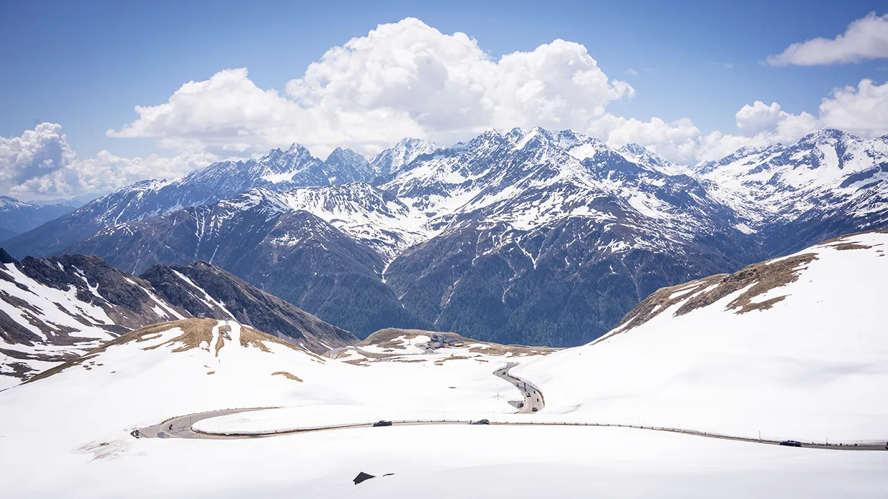 A sweeping vista of the Alps in Europe seen from atop an alpine pass